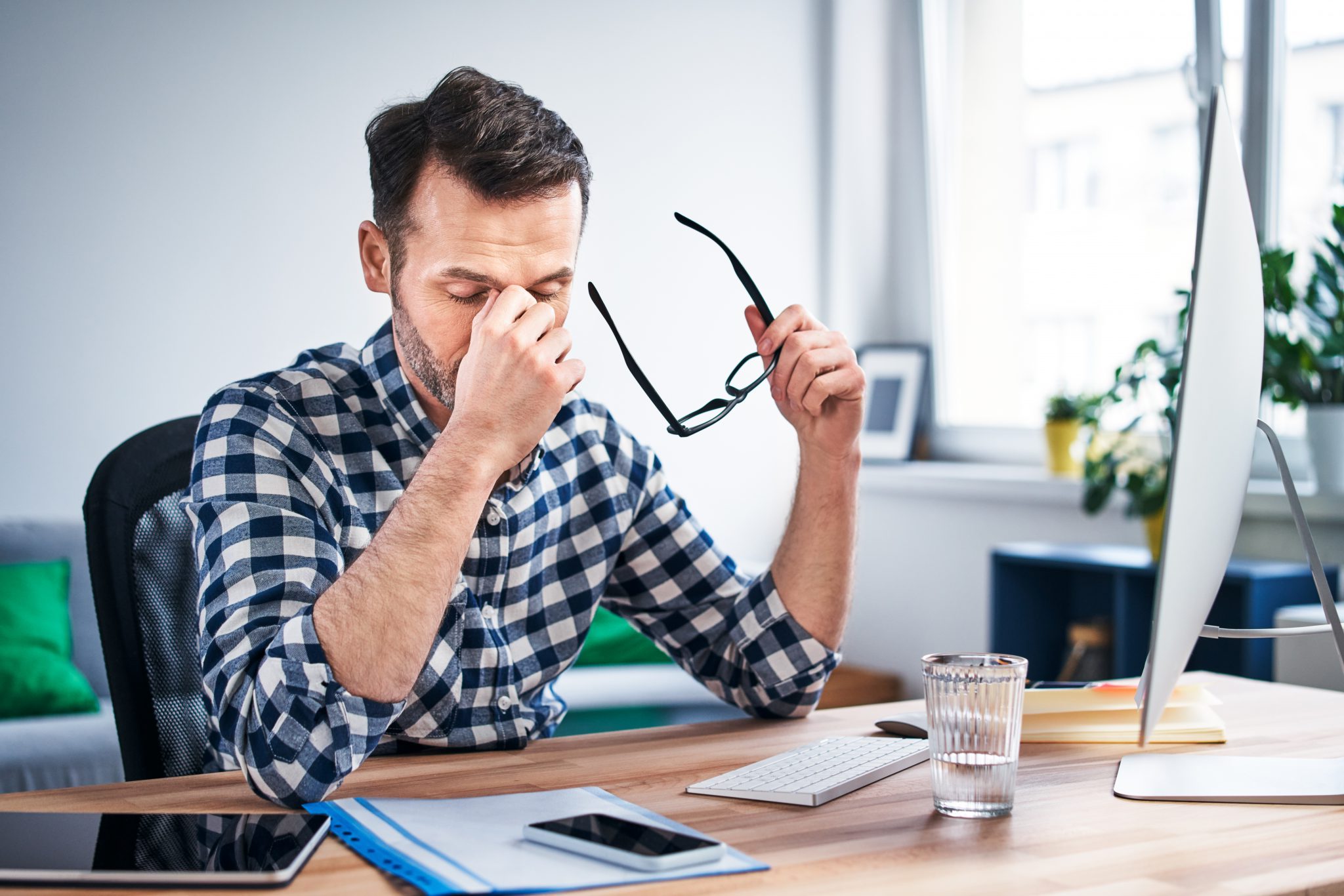 Frustrated, overworked freelancer working from home office Frustrated, overworked freelancer working from home office